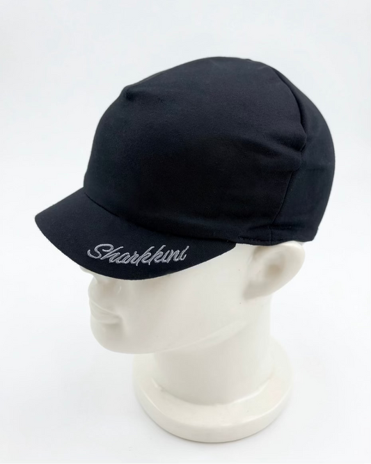 A black jersey brim beanie with 'Sharkkinii' embroidered in grey script on the brim