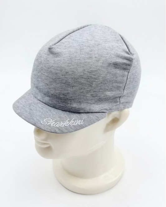 A light gray heathered  cap with a curved brim, displayed on a white mannequin head. The brim features white cursive embroidery reading 'Sharkkini'.